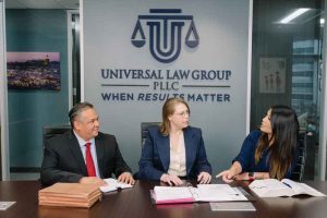 Houston traumatic brain injury attorneys discussing a case at the Universal Law Group office