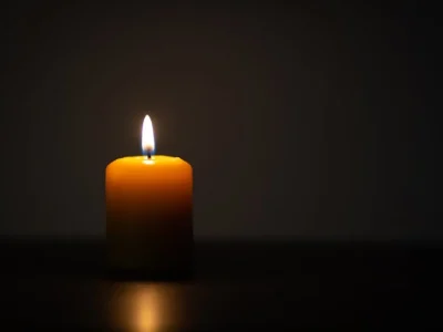 A single lit candle in a dark room - infant wrongful death