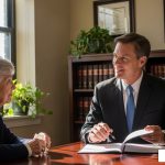 compassionate lawyer reviewing documents with a grieving family member - how to prove wrongful death