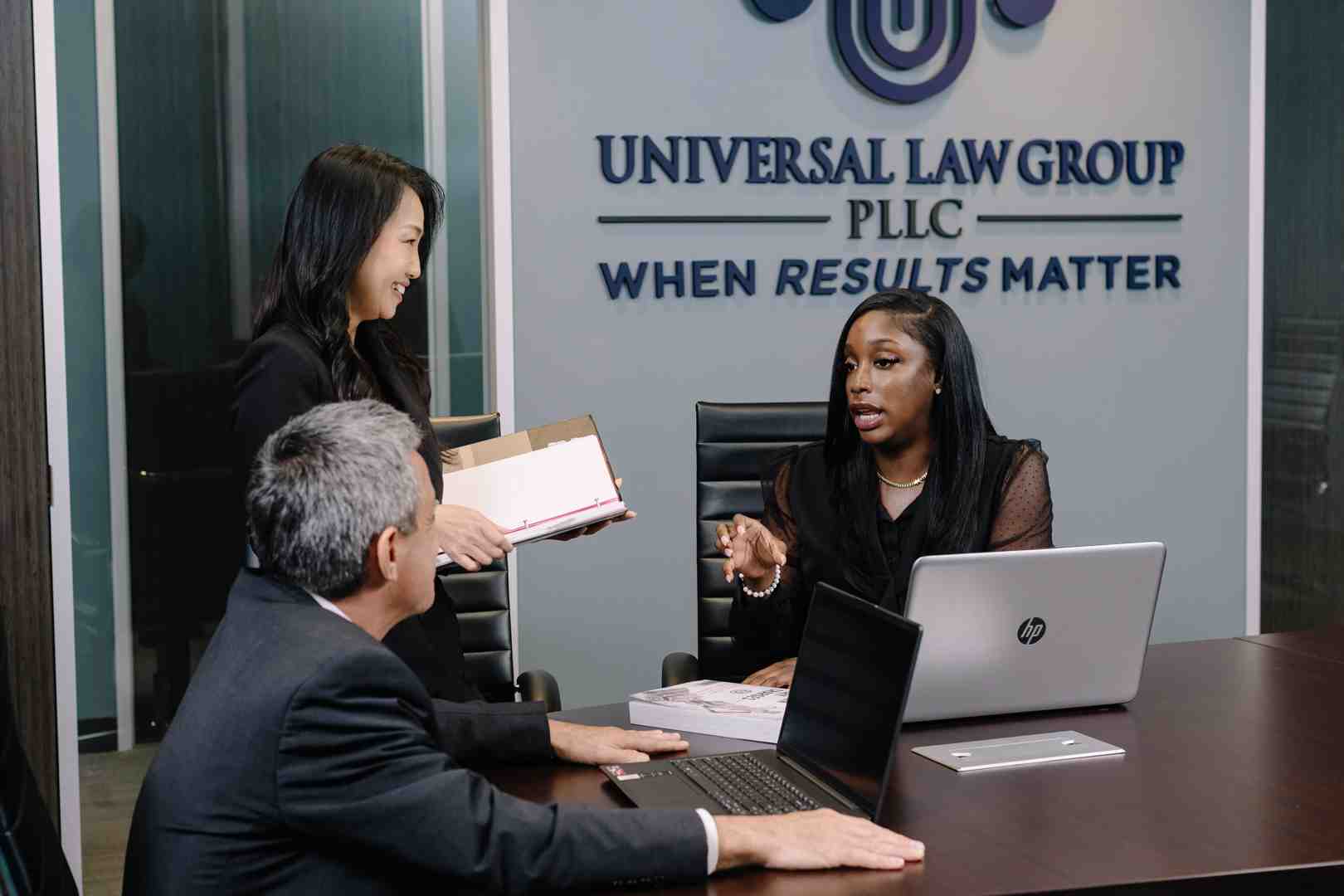 Universal Law Group attorneys reviewing a truck accident case file in their Houston office