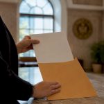 Hands holding a legal restraining order envelope